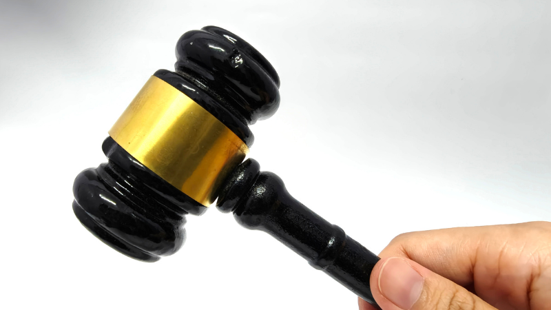 Clicks Gorilla Google Ads Auction and Bidding Strategy A judge's gavel held in hand, representing the Google Ads auction process and strategic bidding management provided by Clicks Gorilla.