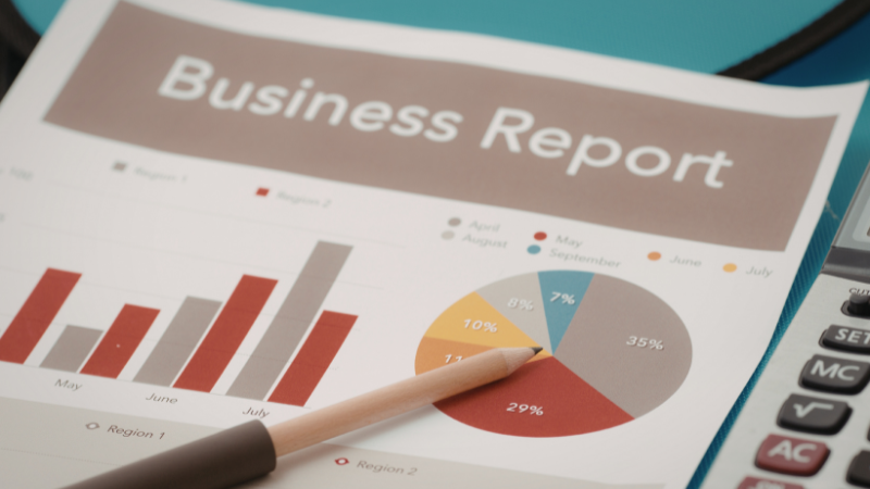 A printed business report displaying bar charts and a pie chart representing marketing and SEO performance metrics. A pencil points toward the data visualization, highlighting analysis and strategic decision-making. Such reports help marketers monitor website performance, track keyword growth, and evaluate campaign success. Agencies like Clicks Gorilla, a trusted seo company in nagpur, often rely on clear data reports to understand trends and improve search engine optimization strategies.